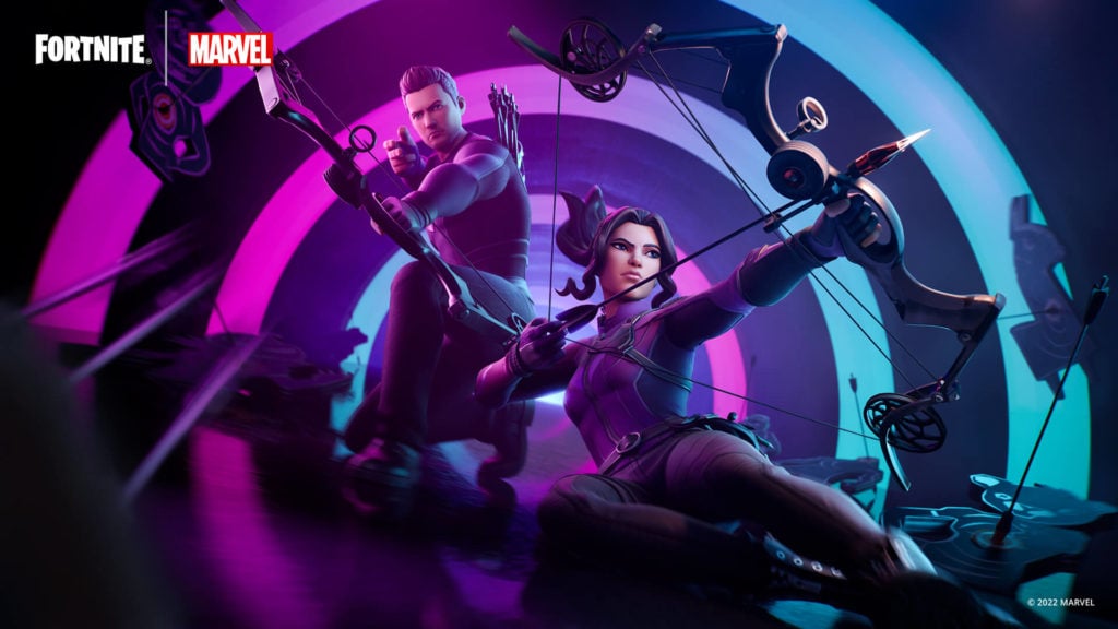 Kate Bishop slides into center frame with Clint Barton kneeling behind her both wielding bow and arrows.