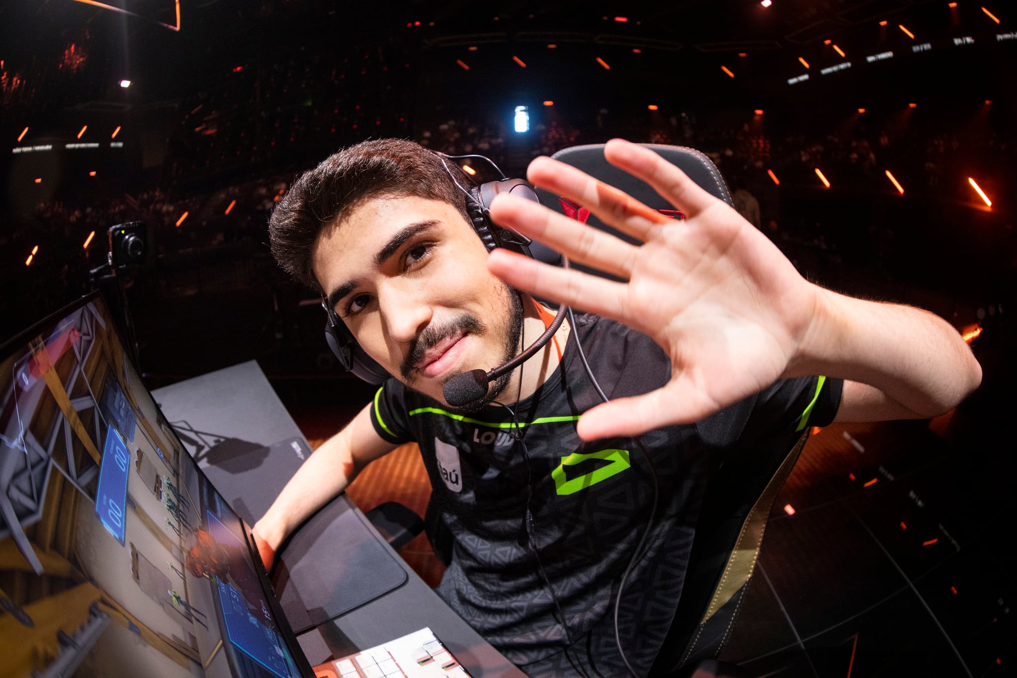 Aspas at his computer waving at the camera man