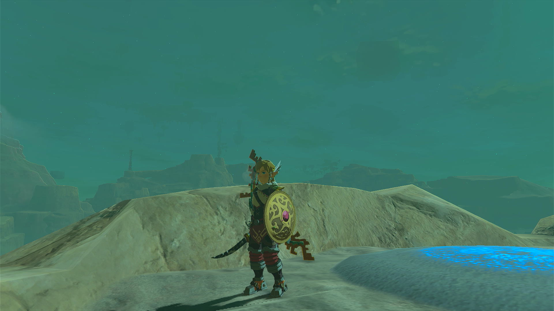 Link standing in front of a shrine wielding the Gerudo Scimitar and Shield.