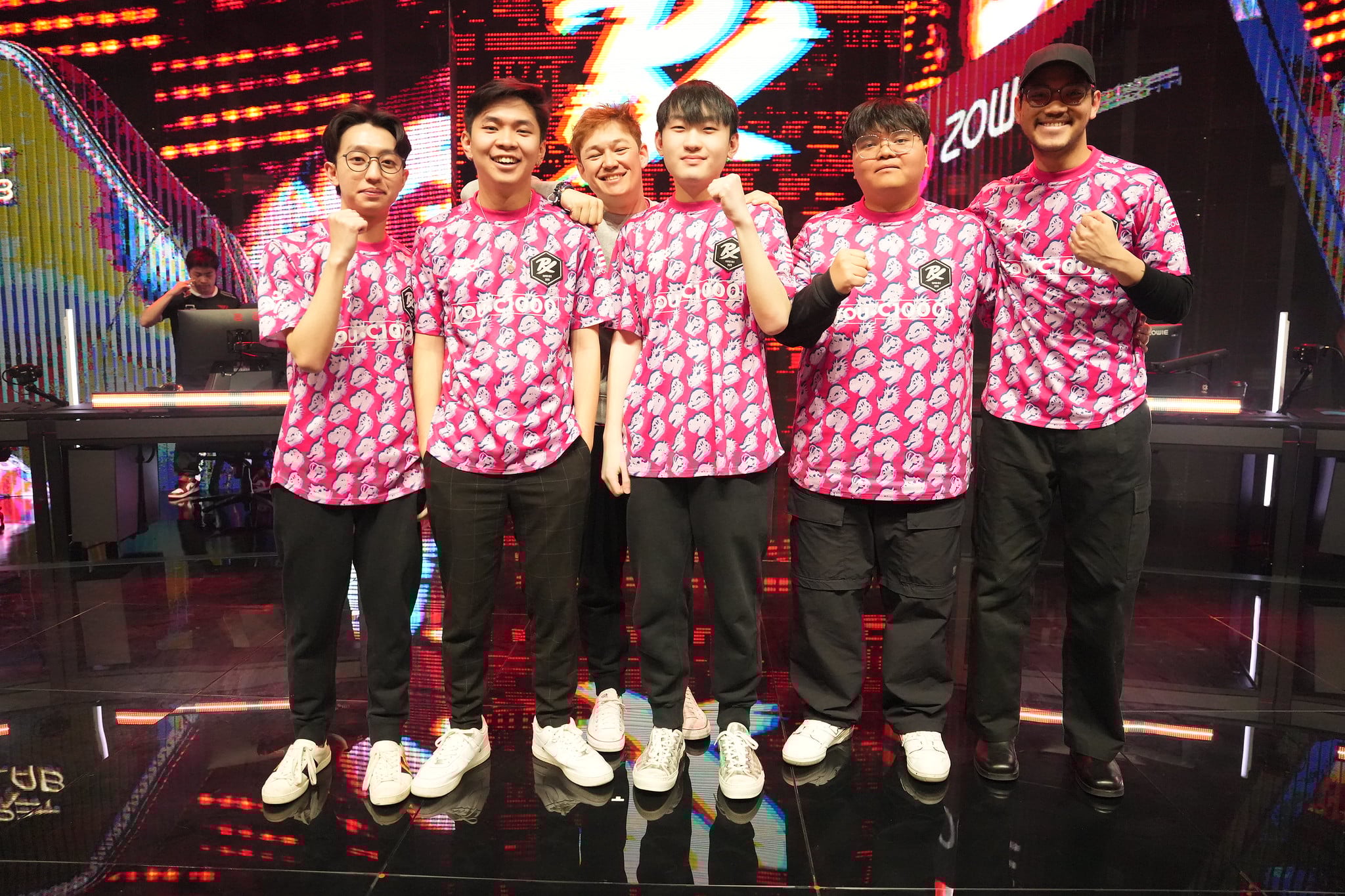 Paper Rex stand on stage after a regular season match in VCT Pacific. From left to right stand f0rsakeN, mindfreak, alecks (coach), Jingg, d4v41, and Benkai.