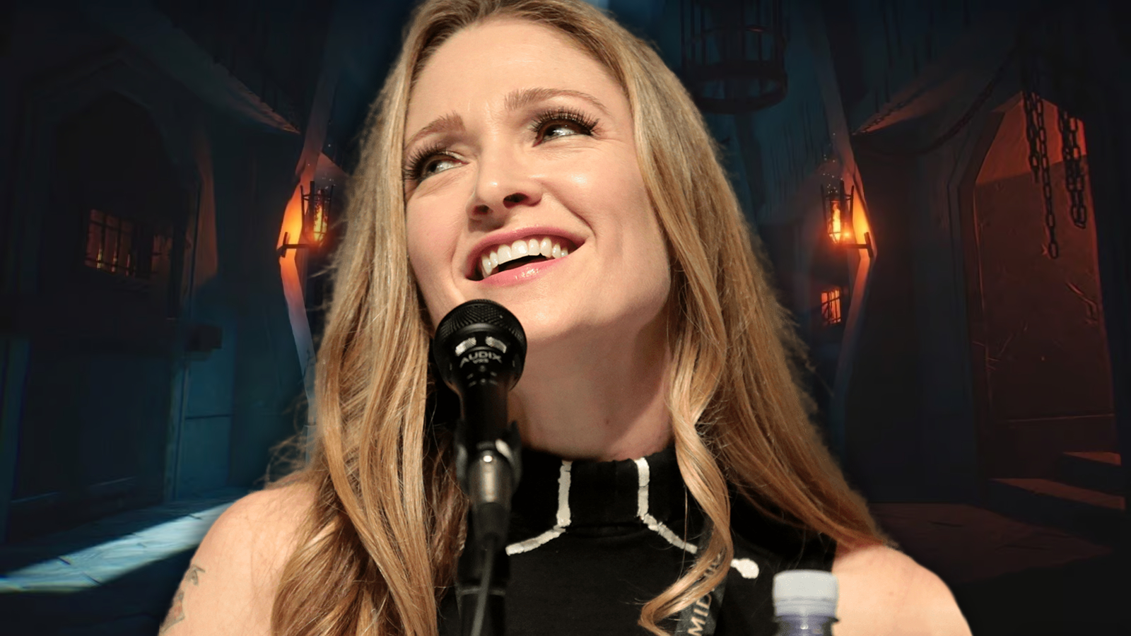 Julia Nathanson laughs while speaking into a microphone in front of an edited image from League of Legends