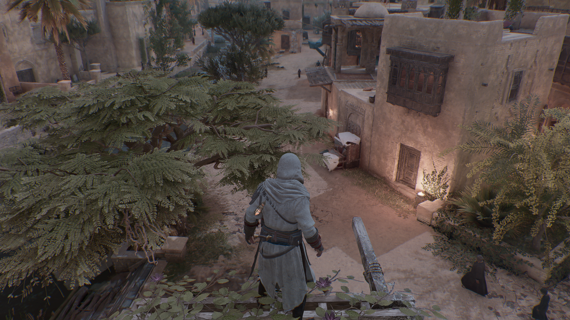Image of a man in a white robe standing on the edge of a building.