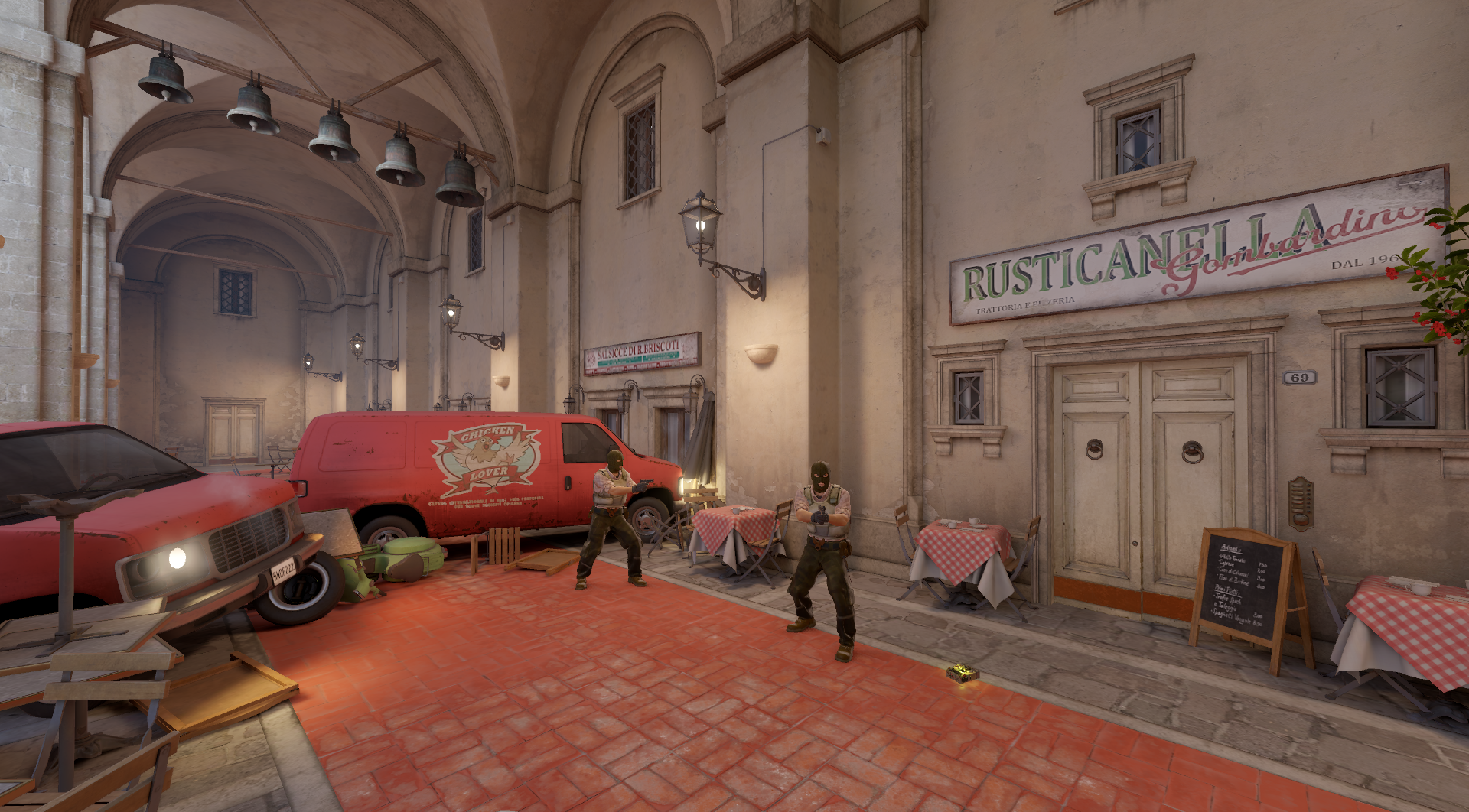 Screenshot taken of Inferno's T Spawn in CS2, featuring two Terrorists holding pistols and the bomb on the ground.