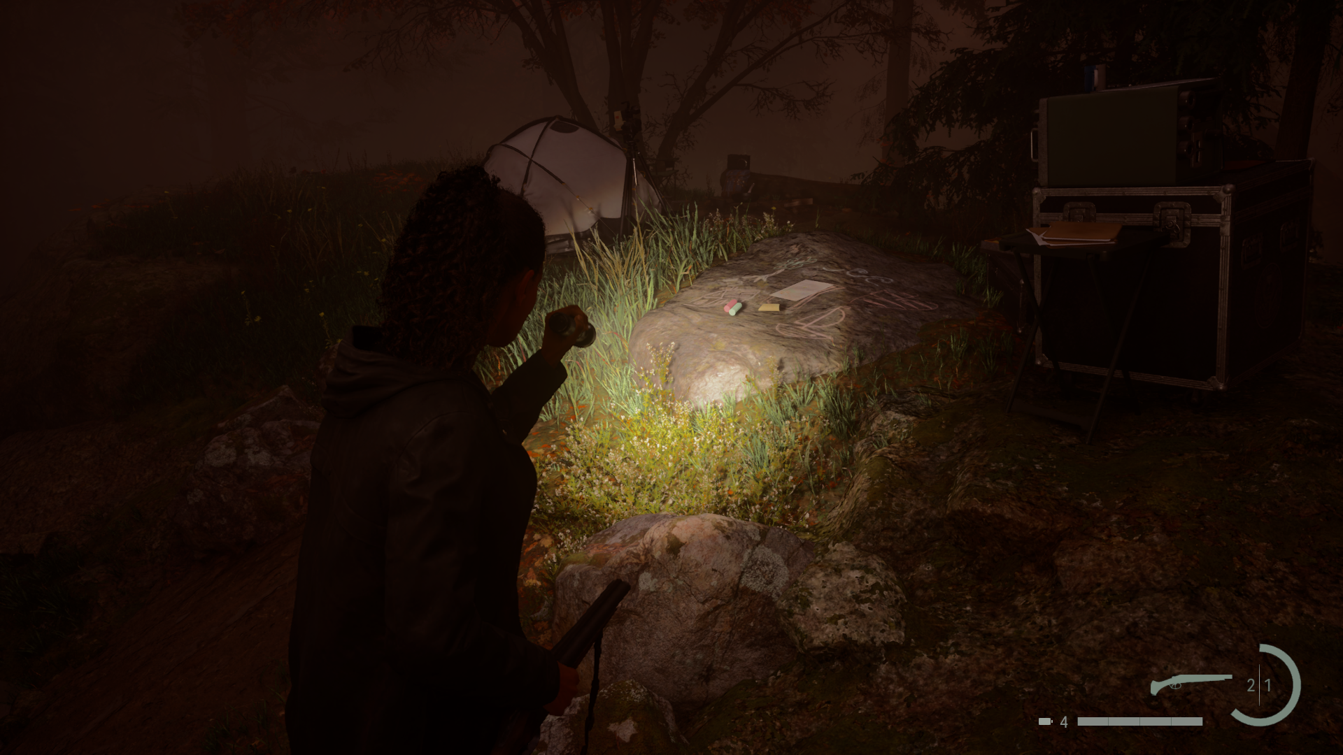 Saga's flashlight illuminating a Nursery Rhyme on the forest floor at night in Alan Wake 2.