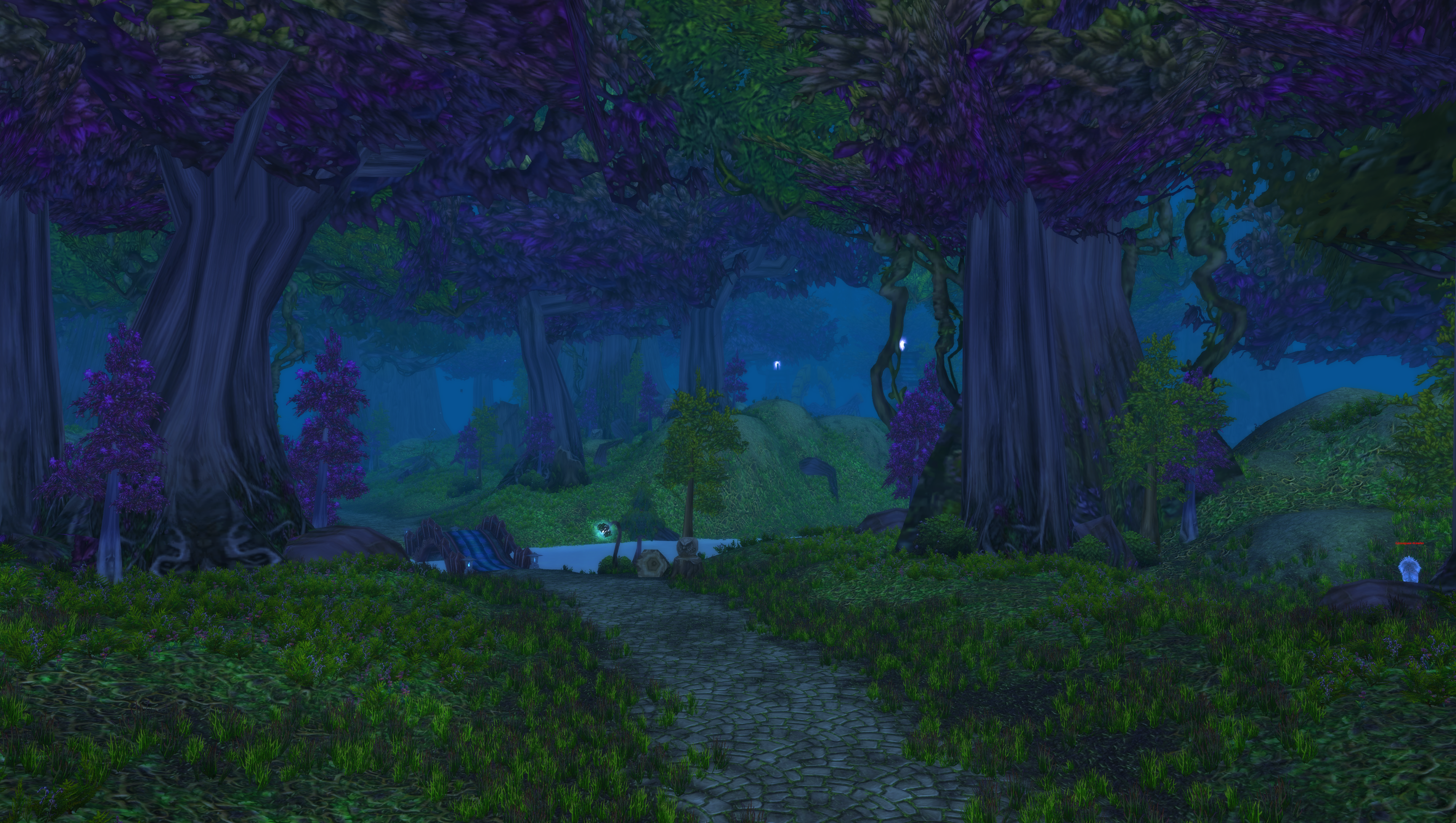 A WoW screenshot featuring the main road that runs through the entirety of Ashenvale, along with some trees and lush forests propping up the background of the image