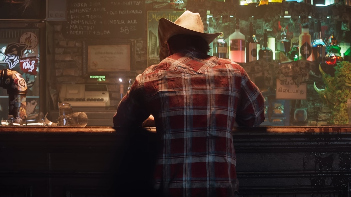 A guy seen from the back in a bar.