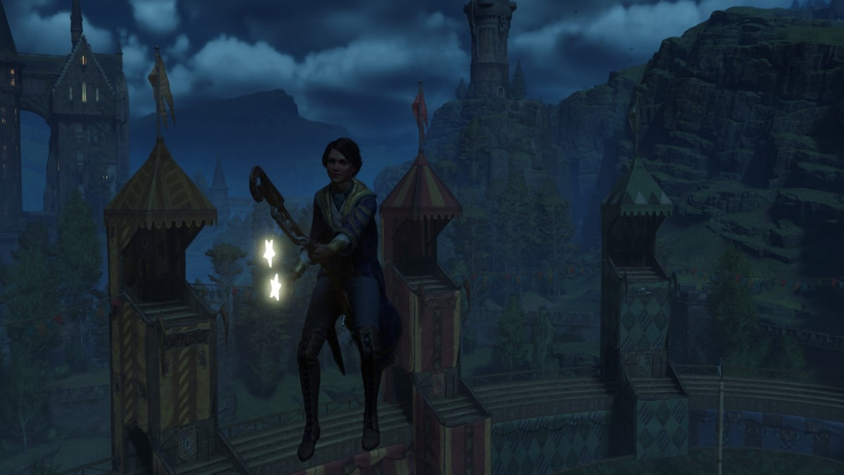 The player hovering in the air while riding a broom in Hogwarts Legacy.
