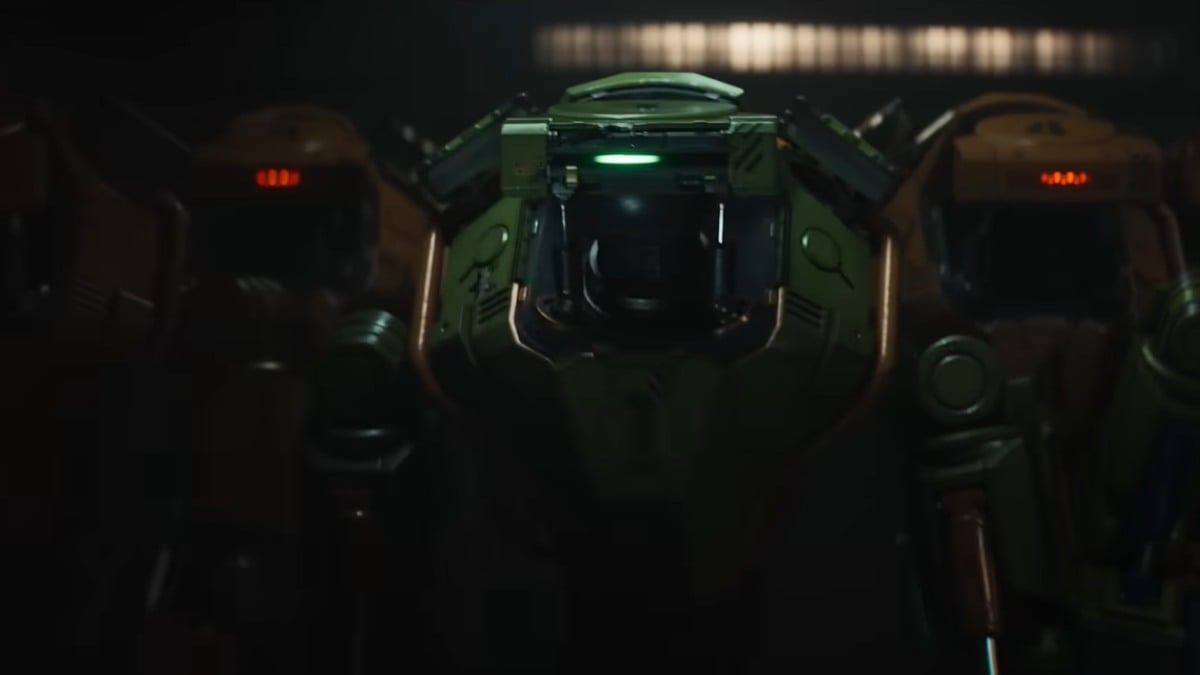 Robot Xan standing at the center with later robot models to their left and right