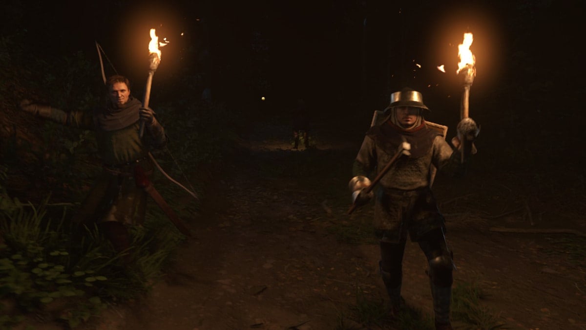 Two guards holding torches clad in full armor at night approaching the player