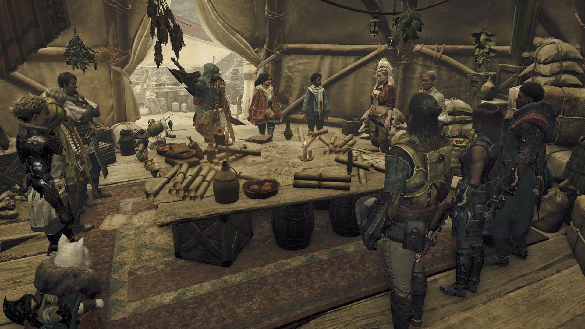 A group of people in armor and exploration gear stand around a table littered with maps and scrolls inside of a large tent.