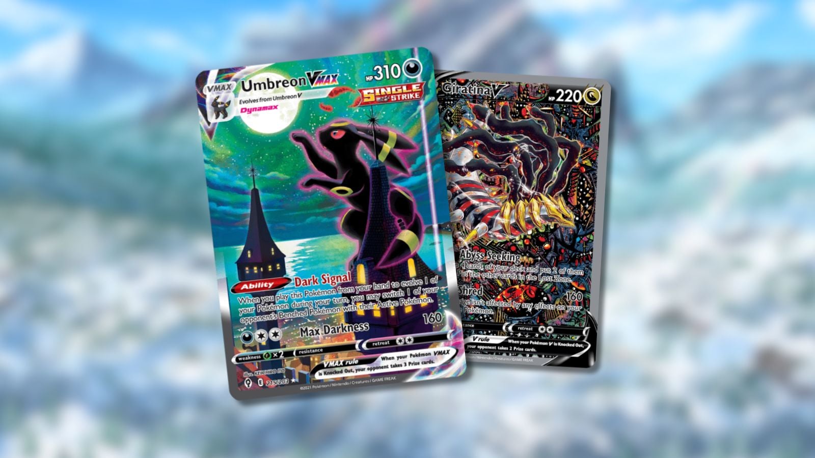 Moonbreon Pokemon card and Giratina V Pokemon card on blurred mountain background.