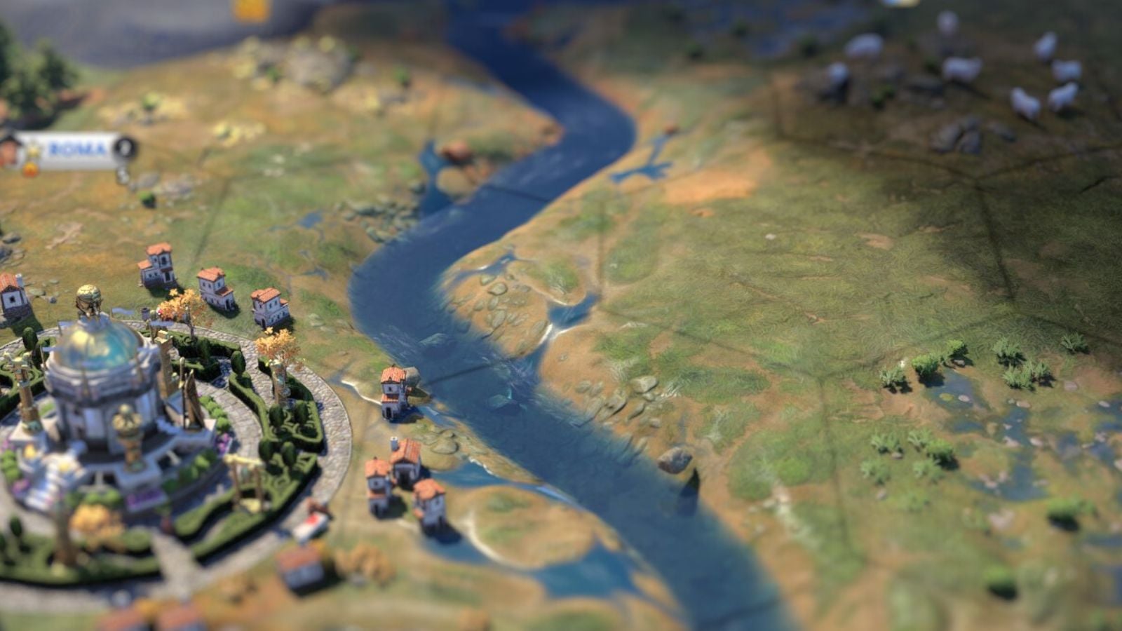 Tilt shift edit of a Civilization 7 settlement just next to a river in the grass.