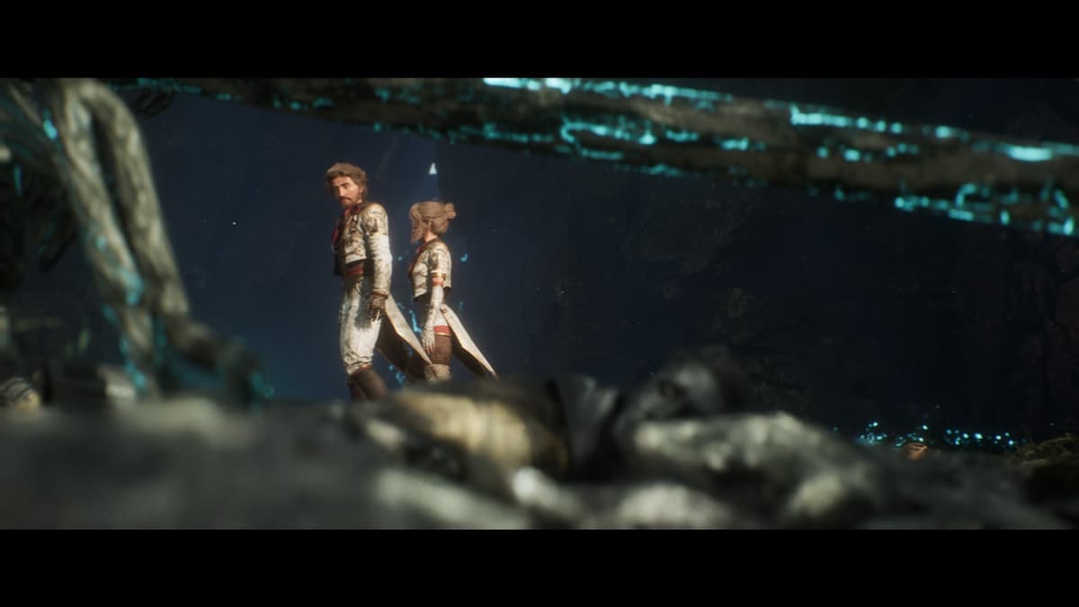 Gustave and Lune dressed in white uniforms traverse a ruined cave in Clair Obscur: Expedition 33.