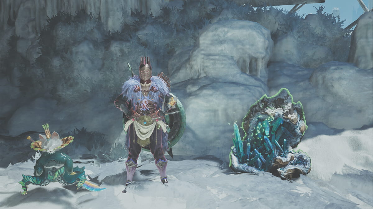 A hunter and Palico stand in a snow cave.