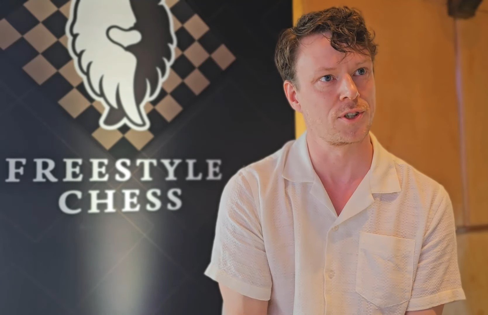 taketaketake's ceo giving an interview in front of a freestyle chess board