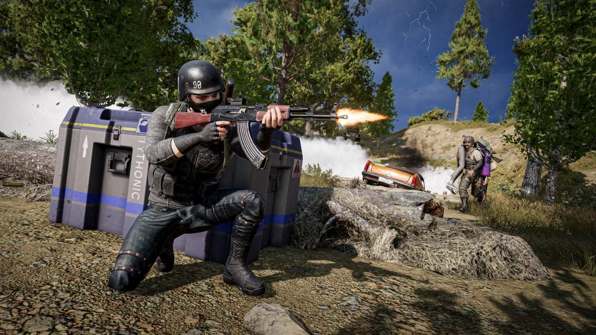 A player carrying a squadmate while another provides covering fire.
