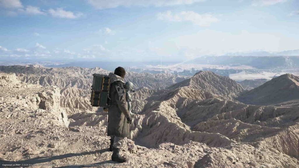 Picture showing the protagonist standing in the sunny hills in Death Stranding 2.