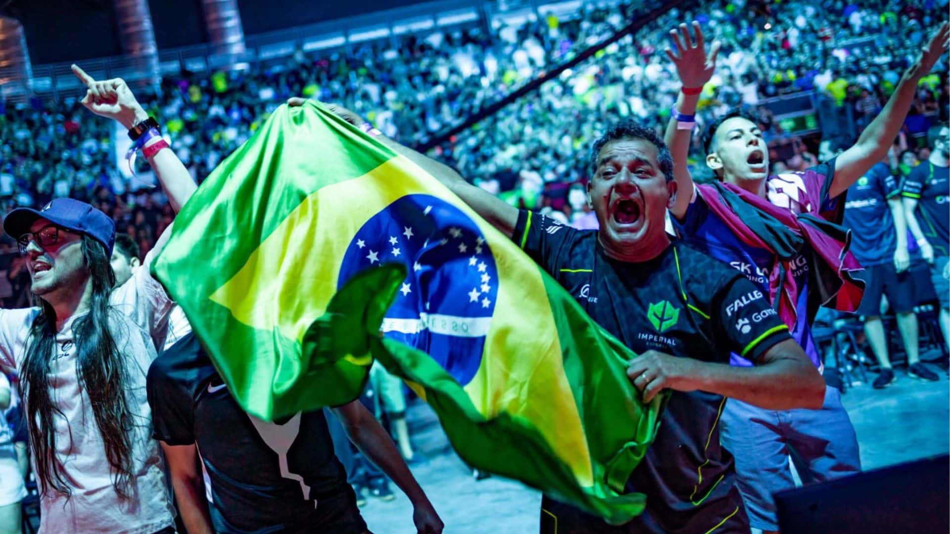 A man scremas while waving the flag of Brazil during an ESL Counter-Strike tournament.