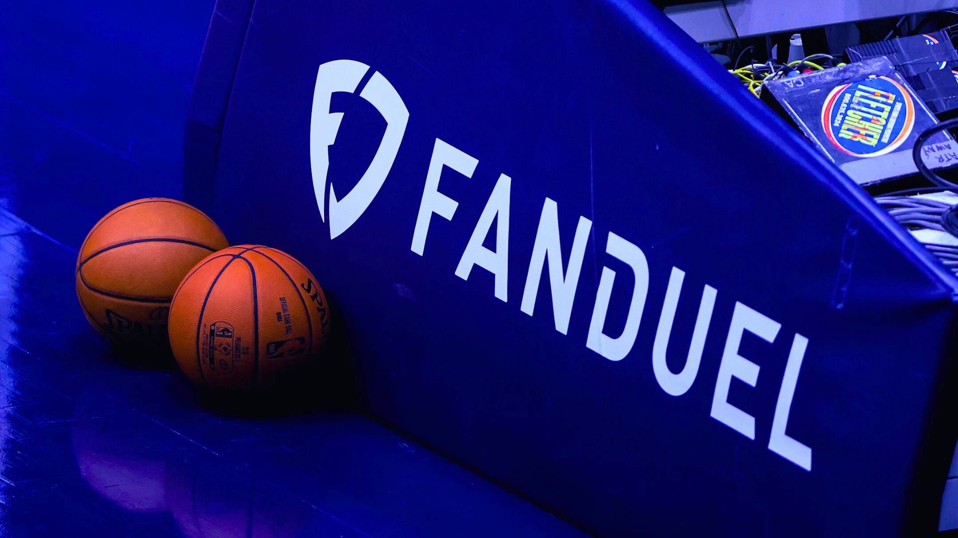 FanDuel logo and brand name displayed on a basketball court.