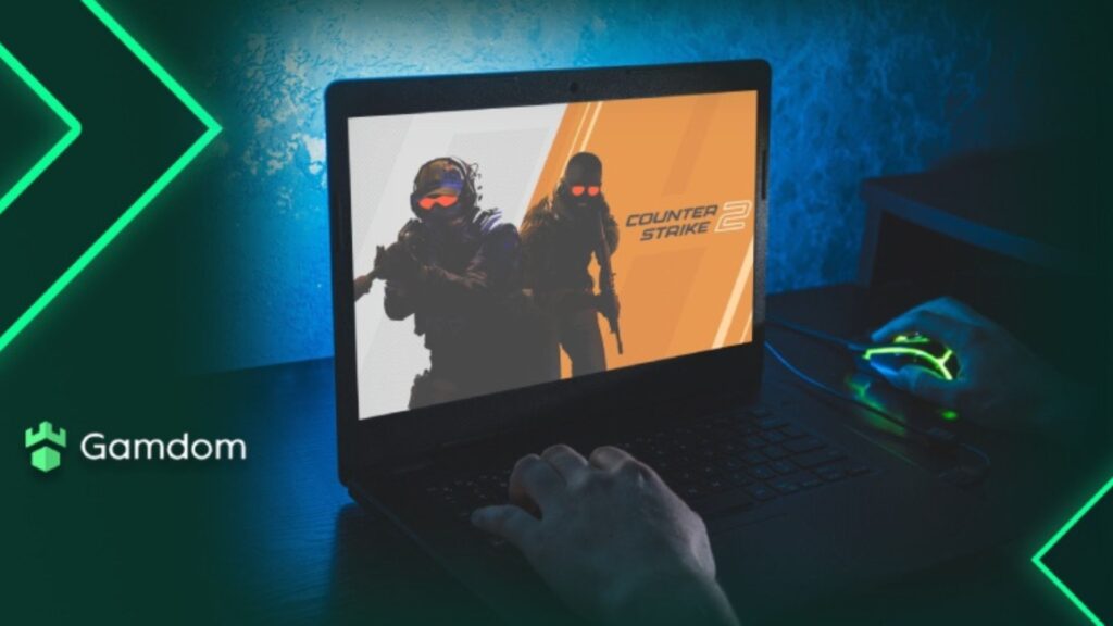 Loading screen of CS2 on laptop with image design from Gamdom.
