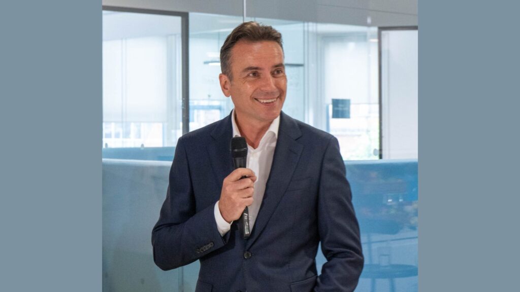 Kambi CEO Werner Becher holding a microhpne