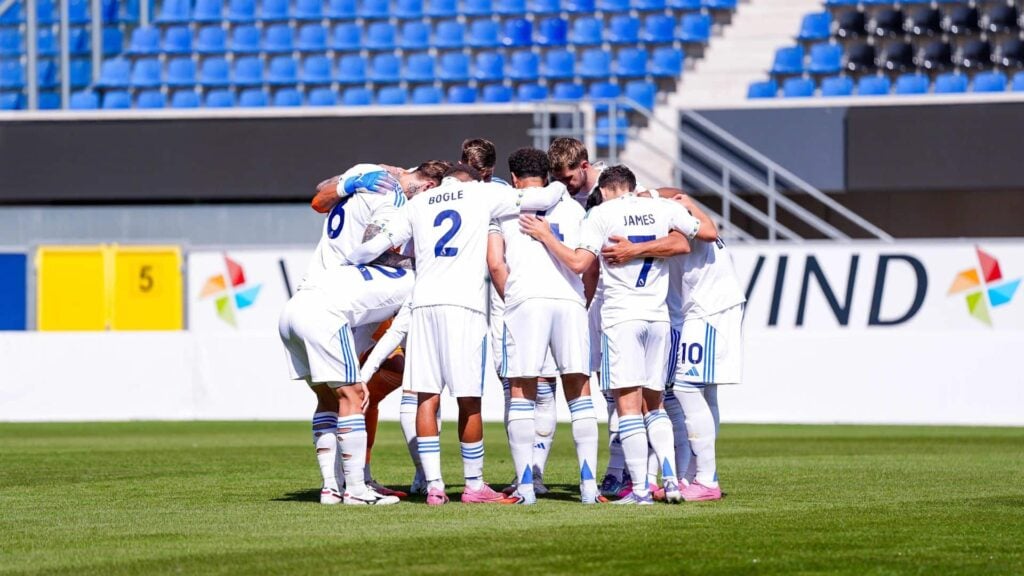 Leeds United players huddle during a match.