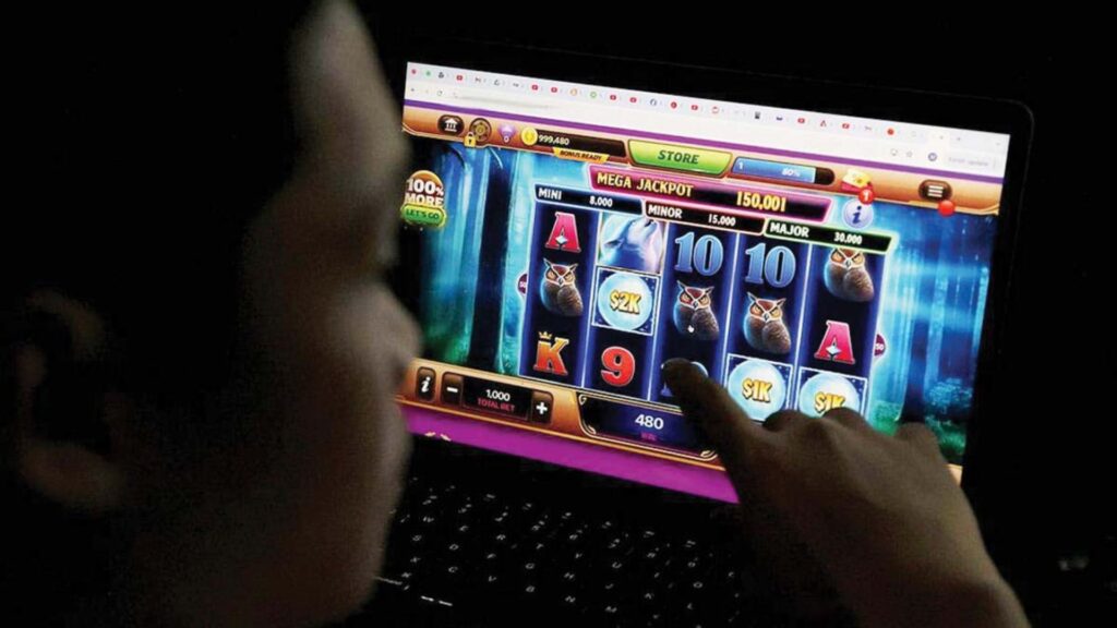 A Filipino playing an online casino game on a laptop.