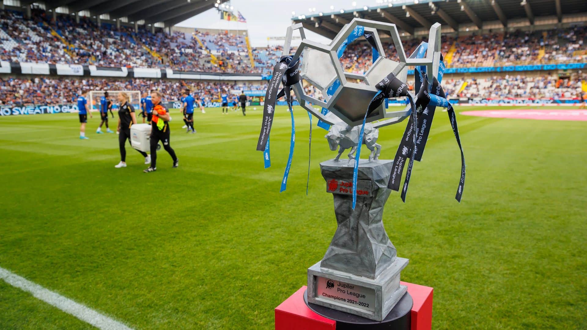 Belgian Pro League trophy placed inside a football stadium.