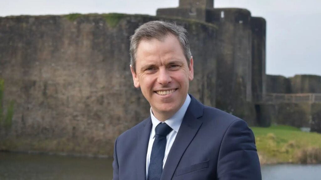 Chris Evans MP portrait against a castle.