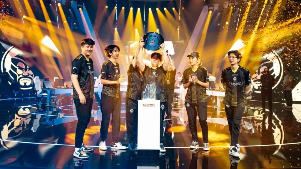 Mzinho lifts the trophy as The Mongolz celebrate their victory at EWC 2025 CS2 tournament.