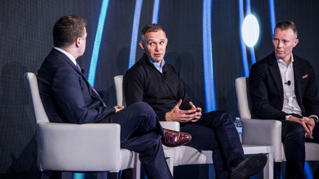 Flutter CEO Peter Jackson (center) and CFO Rob Coldrake (right) during a fireside chat with Morgan Stanley's Ed Young at Morgan Stanley Technology, Media & Telecom Conference.