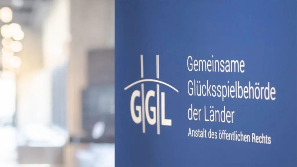 GGL logo and name set against a blue background and blurred office.