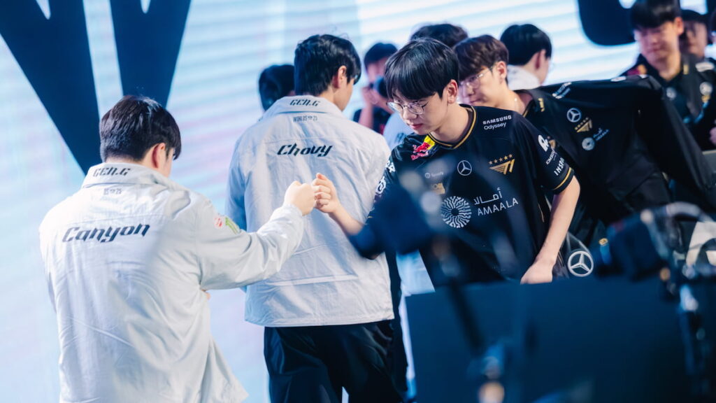 Gen.G Esports (L) and T1 shake hands at League of Legends Worlds 2025 Swiss Stage on October 18, 2025 in Beijing, China.