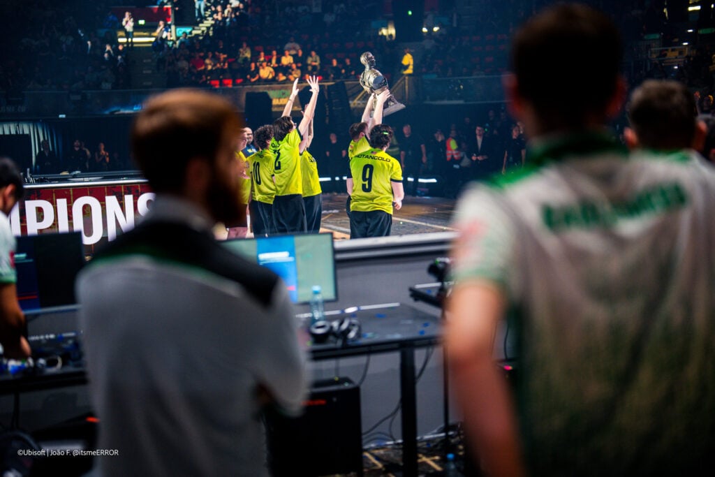 Falcons watch on as M80 lift the Munich major trophy.
