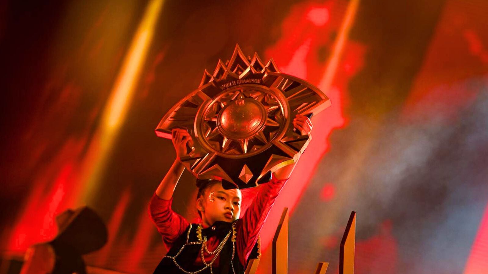 A woman carrying the MLBB World Championship trophy during M7 in Jakarta, Indonesia